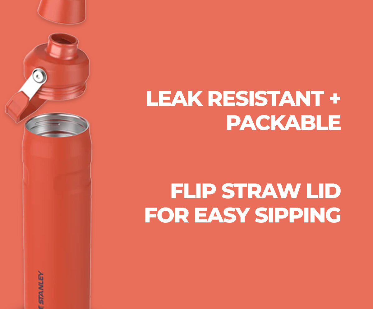 Orange Stanley water bottle with flip straw lid on a red background, featuring text about features