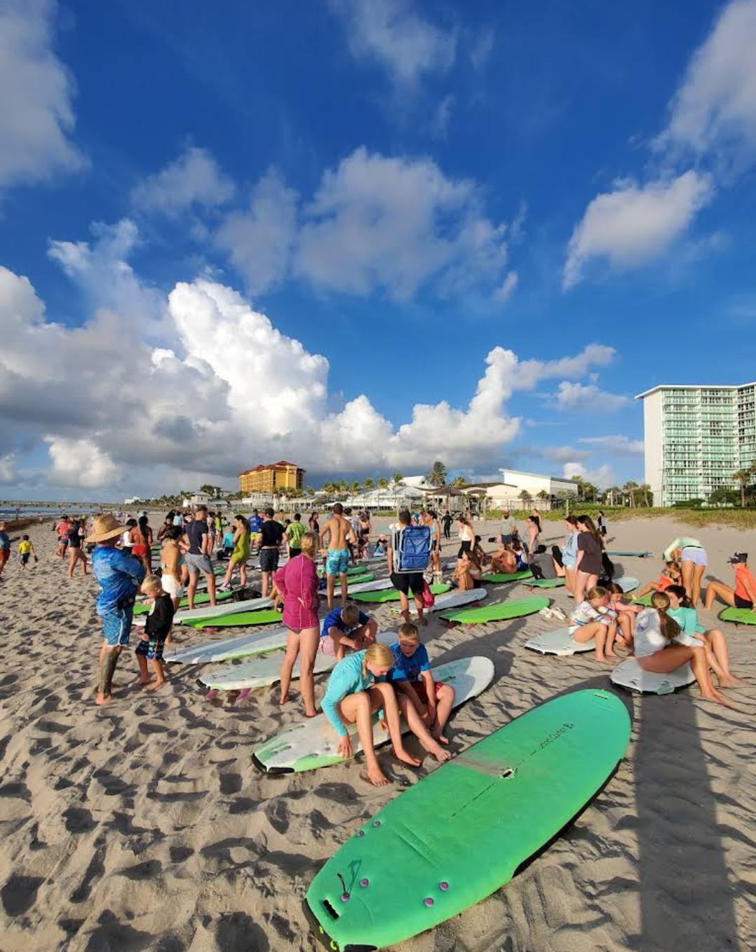 people takign our free surf lessons in deerfield beach